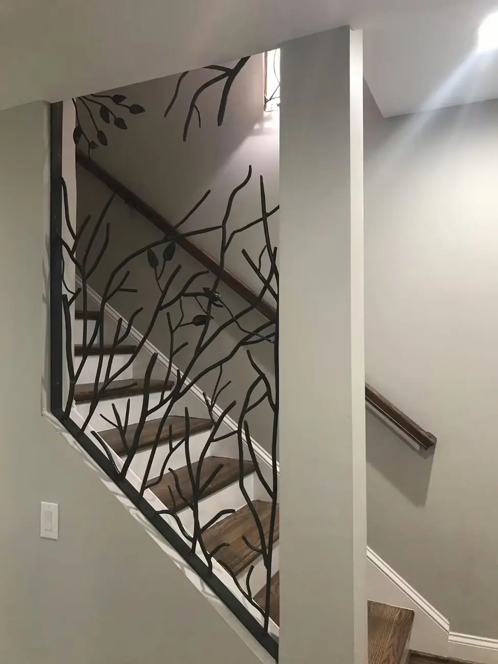 Completed one-off tree-inspired steel railing on an interior landing